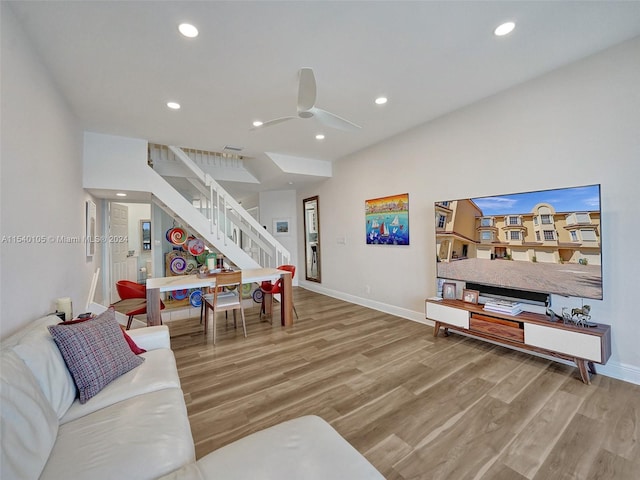 living room featuring light hardwood / wood-style floors and ceiling fan