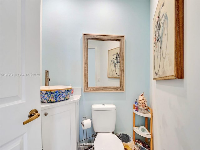 bathroom featuring toilet and vanity