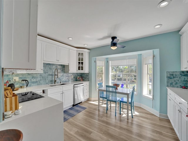 kitchen featuring ceiling fan, sink, light hardwood / wood-style flooring, tasteful backsplash, and white cabinetry