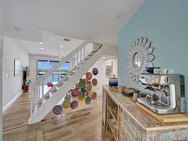 stairs featuring light hardwood / wood-style flooring