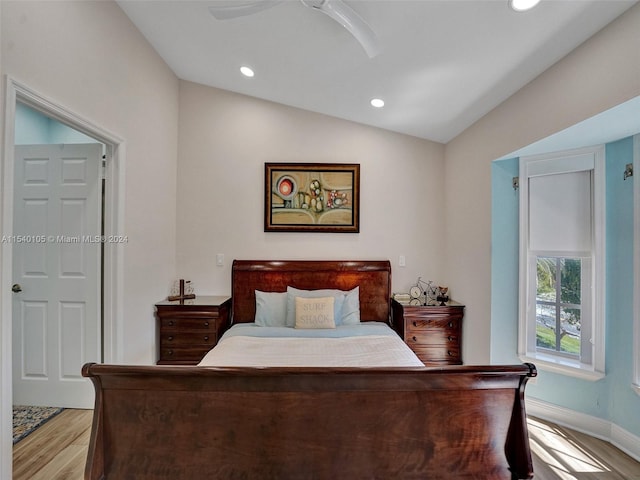 bedroom featuring ceiling fan, vaulted ceiling, and light hardwood / wood-style flooring