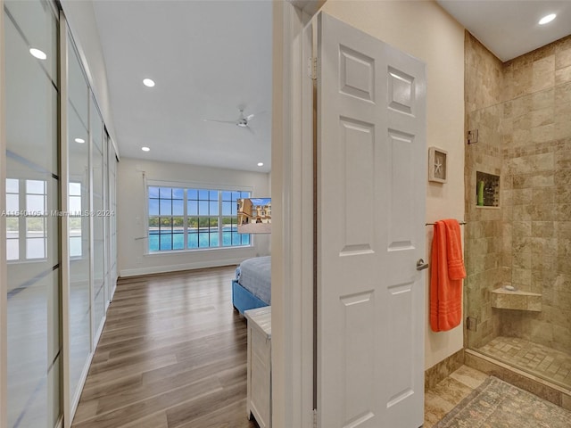 hallway with a water view and light hardwood / wood-style flooring