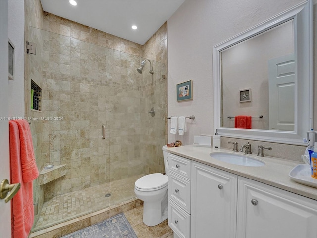 bathroom featuring vanity, tile floors, toilet, and walk in shower