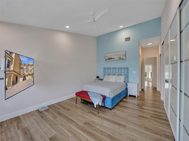 bedroom with ceiling fan and light wood-type flooring