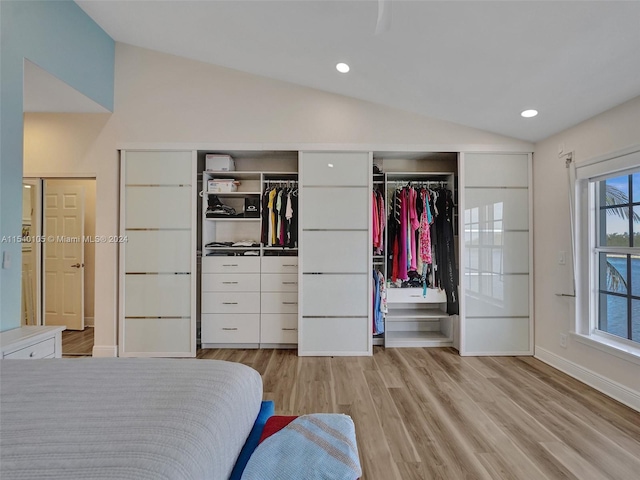 bedroom featuring lofted ceiling and light hardwood / wood-style flooring