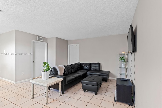 2626 SE 20th Ct Unit 206-B, Homestead, FL 33035 - living room featuring light tile patterned flooring and a textured ceiling