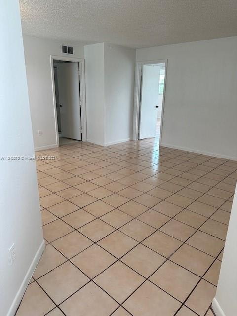 2626 SE 20th Ct Unit 206-B, Homestead, FL 33035 - empty room with light tile patterned floors and a textured ceiling
