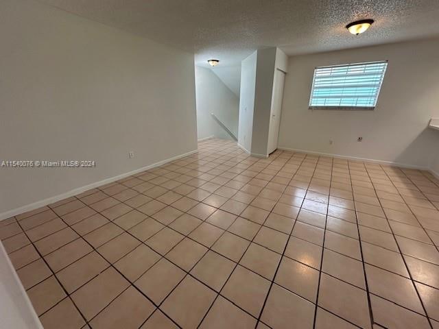 2626 SE 20th Ct Unit 206-B, Homestead, FL 33035 - unfurnished room featuring light tile patterned floors and a textured ceiling