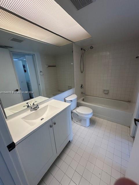 2626 SE 20th Ct Unit 206-B, Homestead, FL 33035 - full bathroom featuring tile patterned floors, tiled shower / bath combo, vanity, and toilet