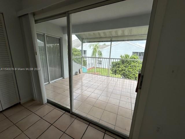 2626 SE 20th Ct Unit 206-B, Homestead, FL 33035 - doorway to outside featuring light tile patterned floors