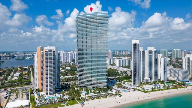 property's view of city featuring a water view and a view of the beach