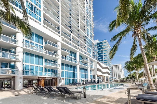 view of building exterior featuring a community pool