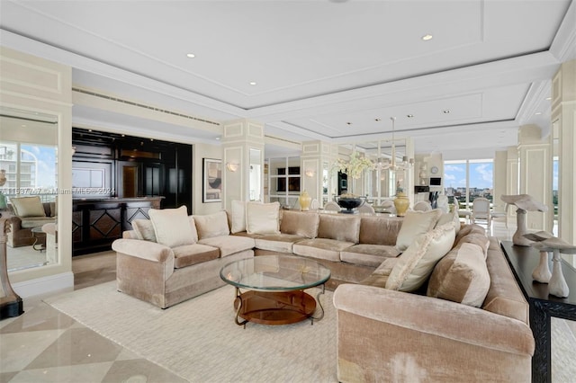 living room featuring light tile floors, a chandelier, a raised ceiling, and ornamental molding