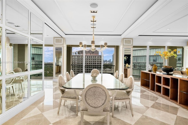 dining room featuring light tile floors, floor to ceiling windows, a chandelier, and a raised ceiling