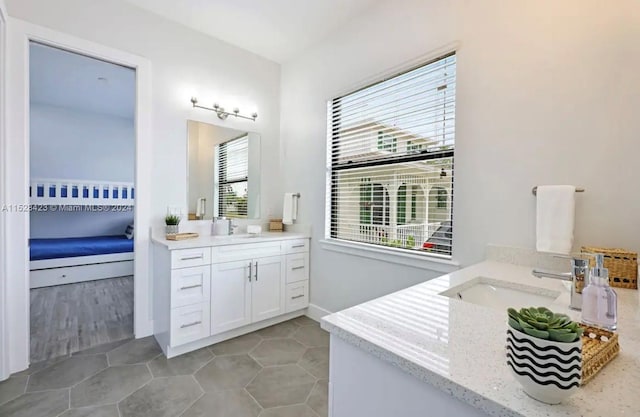 bathroom featuring tile flooring, vanity, and a wealth of natural light