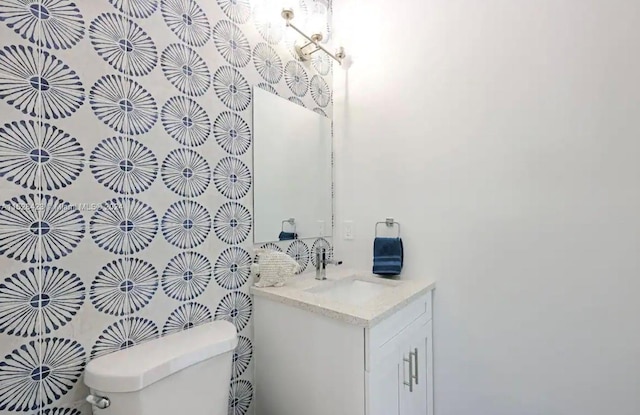 bathroom featuring toilet and vanity