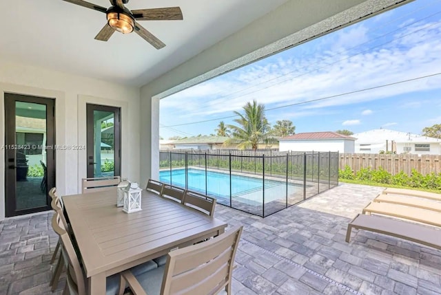 view of patio featuring ceiling fan and a fenced in pool