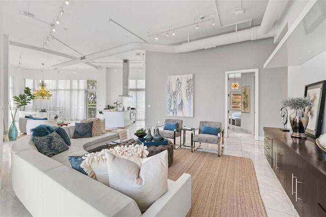 tiled living room with a high ceiling and track lighting