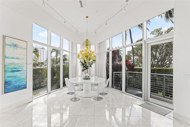 unfurnished sunroom featuring plenty of natural light and rail lighting