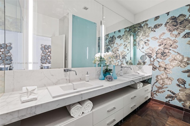 bathroom featuring tile floors, double sink, and vanity with extensive cabinet space