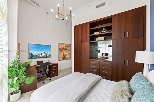 bedroom with light tile floors and an inviting chandelier