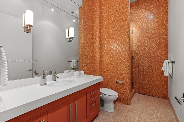 bathroom with toilet, vanity, and tile flooring