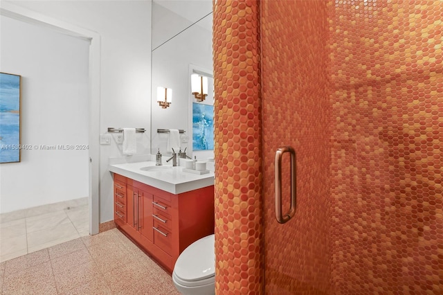 bathroom with toilet, vanity, and tile flooring