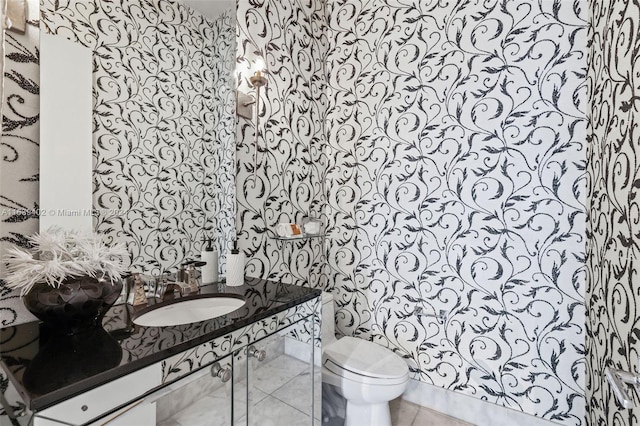 bathroom featuring toilet, tile flooring, and vanity