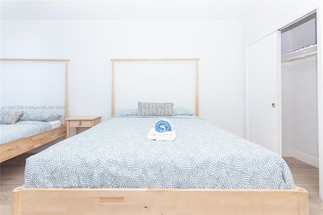 bedroom with a closet and light wood-type flooring