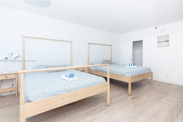 unfurnished bedroom featuring light hardwood / wood-style floors and a closet