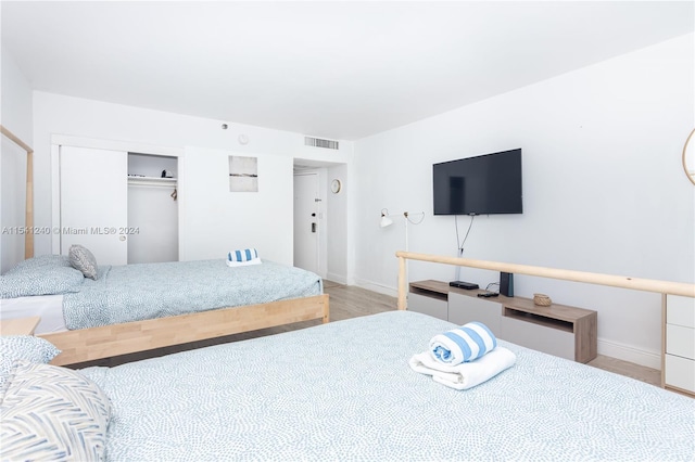 bedroom featuring a closet and light hardwood / wood-style flooring