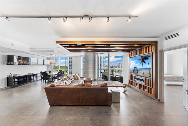 living room featuring dark tile flooring and rail lighting