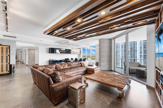 living room featuring track lighting and tile flooring