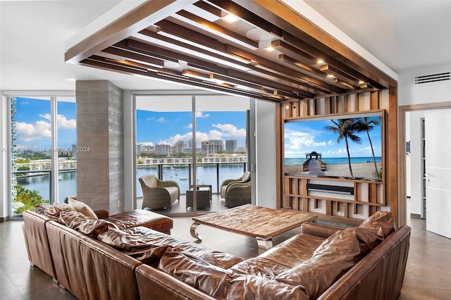 tiled living room featuring a water view and beamed ceiling