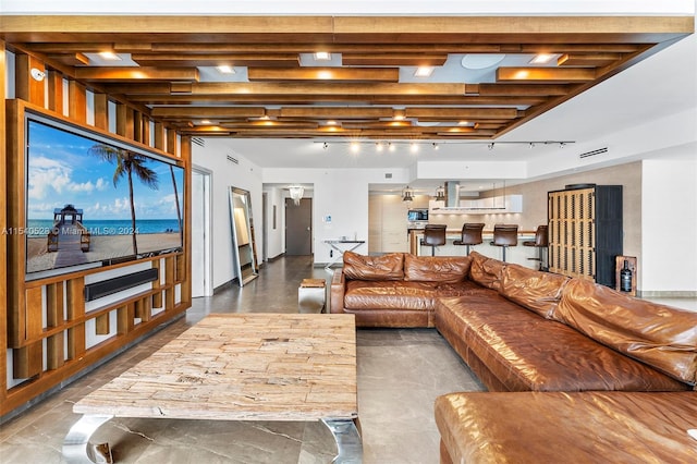 living room with beamed ceiling and a water view