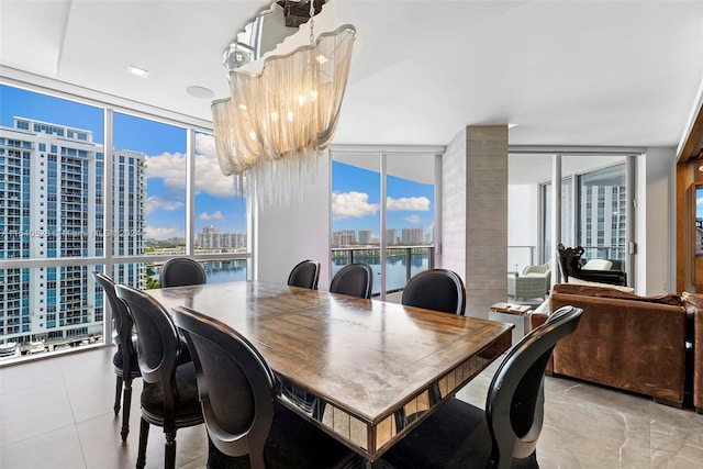 dining space featuring plenty of natural light, expansive windows, and an inviting chandelier