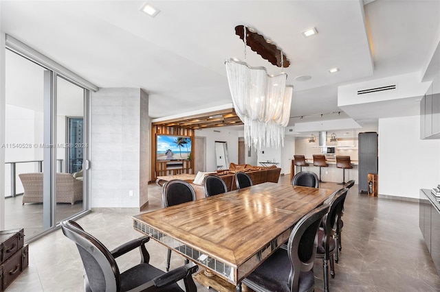 dining space featuring an inviting chandelier and light tile floors