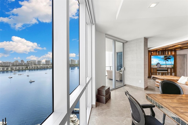 interior space with a water view and light tile floors