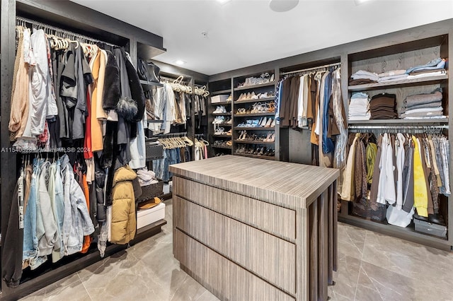 spacious closet featuring light tile floors