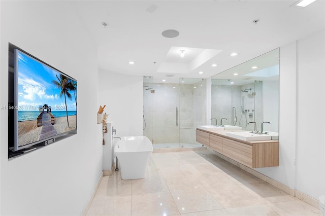 bathroom featuring double sink vanity, tile floors, independent shower and bath, and a water view