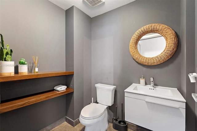 bathroom featuring toilet, tile flooring, and vanity