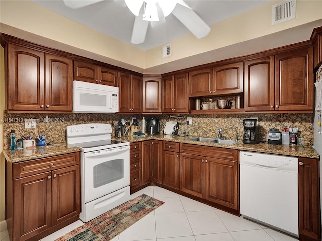 kitchen featuring backsplash, ceiling fan, white appliances, and sink