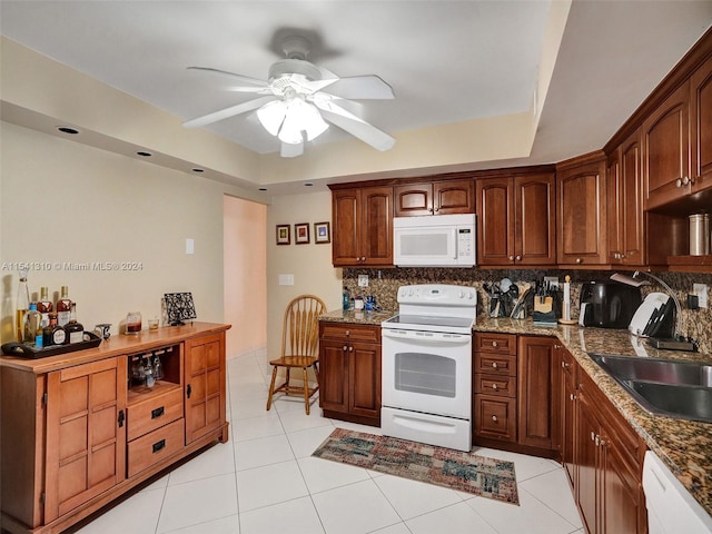 kitchen featuring light tile floors, ceiling fan, white appliances, backsplash, and sink