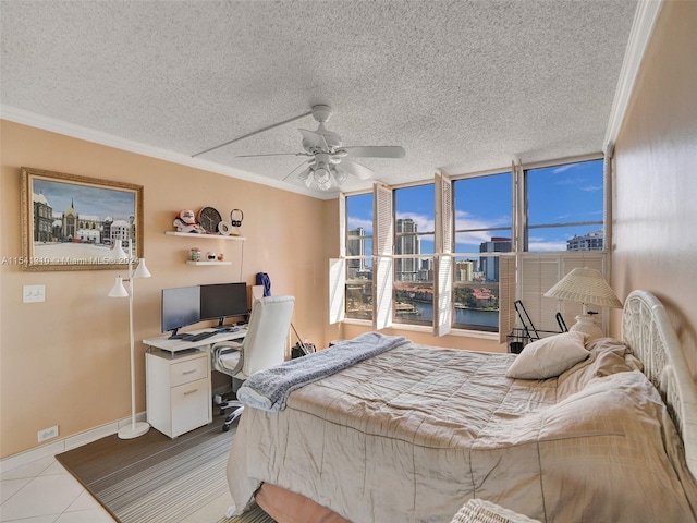 tiled bedroom with multiple windows, crown molding, and ceiling fan