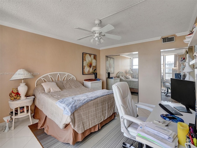 tiled bedroom featuring ceiling fan, a textured ceiling, and crown molding