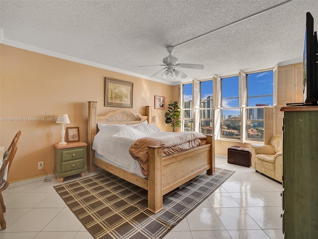 bedroom featuring ceiling fan, a textured ceiling, and crown molding