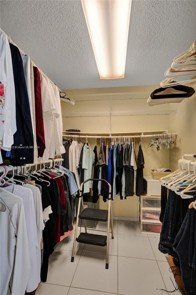 spacious closet with light tile flooring