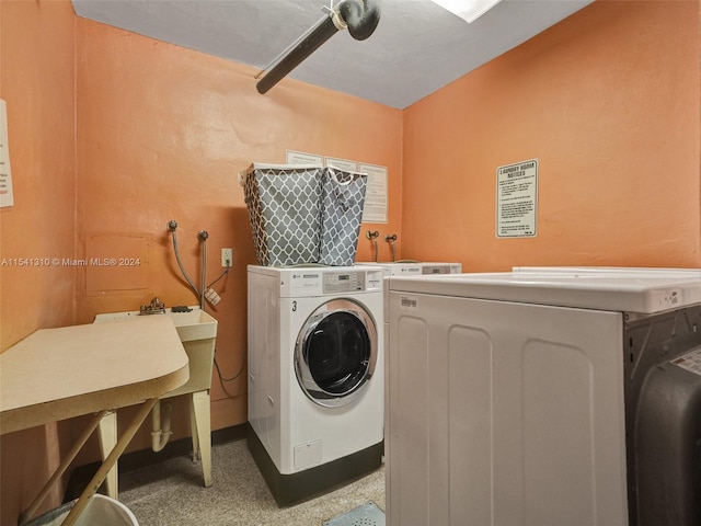 washroom with washing machine and clothes dryer and hookup for a washing machine