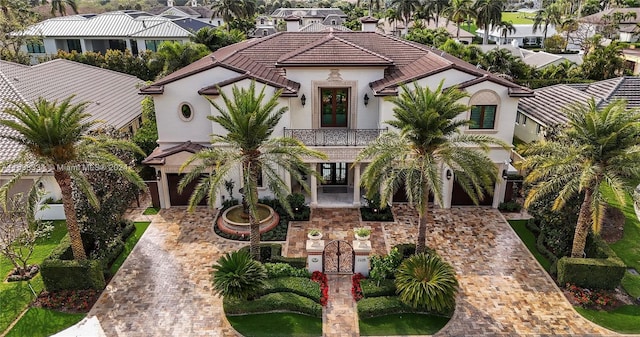 mediterranean / spanish-style home with french doors and a balcony