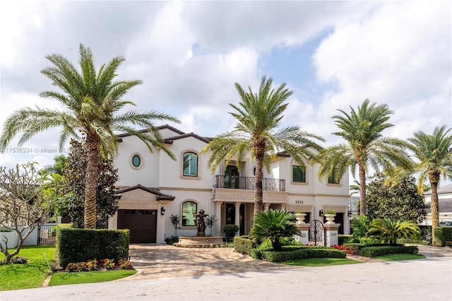 mediterranean / spanish-style home featuring a balcony and a garage